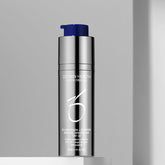 Skincare bottle with blue cap on a gray background